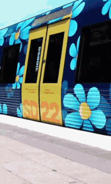 a blue train with flowers painted on it and the number 22