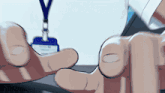 a close up of a person 's hand with a lanyard and a name tag