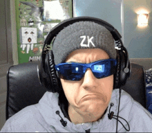a man wearing headphones and a hat that says zk on it