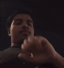 a close up of a man 's hand in the dark