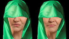 a woman wearing a green hooded jacket covering her face