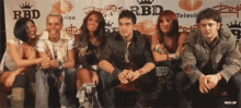 a group of people are posing for a picture in front of a banner that says rbd