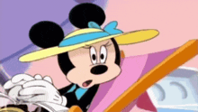 a cartoon of minnie mouse wearing a yellow hat