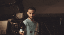 a blurry photo of a man with a beard wearing a blue shirt