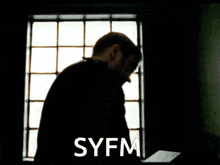 a man in a suit and tie has syfm written on the bottom of his face