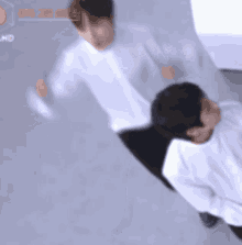 a couple of men are standing next to each other in a room .