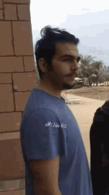 a man wearing a blue t-shirt that says r.o.v.e. to