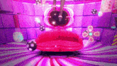 a purple and pink room with a red couch and hearts