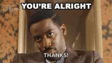 a man in a suit and tie is making a face and saying `` you 're alright thanks '' .