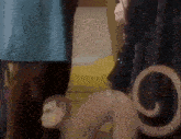 a woman is standing next to a monkey statue .