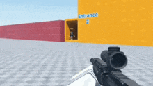 a person holding a gun in front of a building that says entrance 2 on it