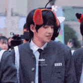 a boy in a school uniform has a name tag that says tender