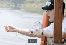a person holding a bag of chips with the word hey on the bottom right