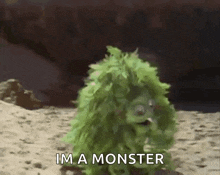 a green monster is standing in the sand and saying i 'm a monster