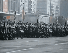 a large group of people marching down a street with a sign that says ' a ' on it