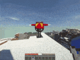 a cartoon character in a red and yellow outfit is standing on a snowy hill