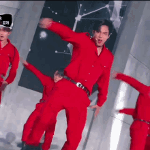 a man in a red shirt and pants is dancing