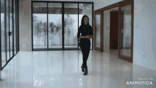 a woman is walking through an empty room with the words made in animotica at the bottom