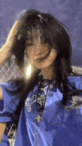 the girl is wearing a blue shirt that says ' i love you ' on it .