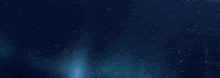 a close up of a blue haired anime girl in a dark room .