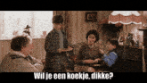 a group of people in a living room with the words wil je een koekje dikke
