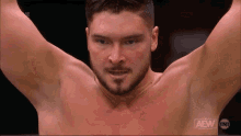 a shirtless wrestler on a wrestling show with the aew logo