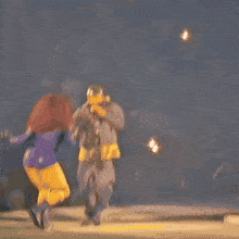 a woman in a superhero costume is being held by a man in a jacket that says shark on the side