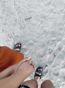 a person holding another person 's hand on a beach
