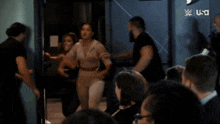 a group of women are having a fight in front of a screen that says usa