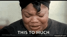 a woman is crying with her eyes closed and the words `` this to much '' written next to her .