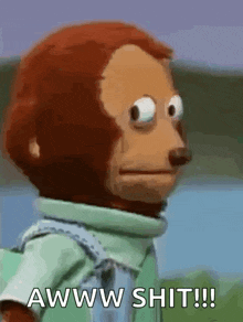 a stuffed monkey with a serious look on his face says aww shit