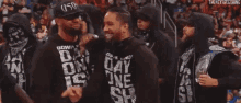 a group of men wearing black shirts with the word day on them