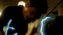 a man is biting another man 's face with his mouth open