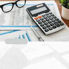 a calculator sits on top of a financial report