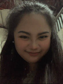 a close up of a woman 's face with long hair