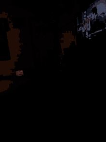 a dark room with a red sign that says exit on it