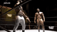 two men in a wrestling ring with the words glory pro on the side