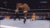 a woman in a wrestling ring with the word dynamite on the bottom right