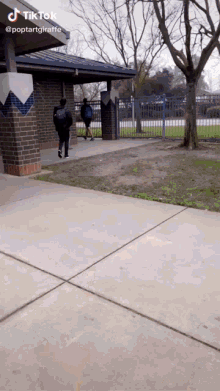 two people walking down a sidewalk with a tiktok watermark