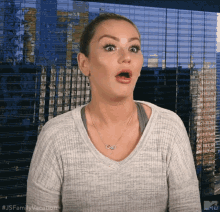 a woman with a surprised look on her face and the words js family vacation on the bottom right