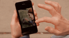 a person is taking a picture of a tree with their phone