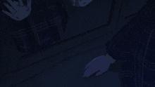 a person 's hands are reaching out in the dark