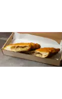 two fried pastries in a cardboard box with a white background