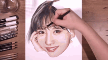 a person is drawing a picture of a woman 's face with a pencil