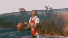 a man in a bulls jersey holds a basketball in his hands