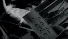 a person is holding a piece of paper that says `` see you later '' in front of a pile of pictures .