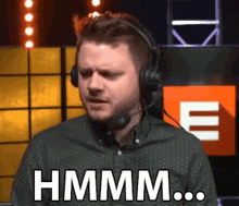 a man wearing headphones is making a funny face and saying hmm .