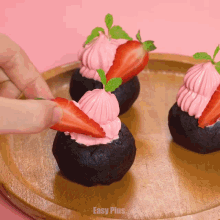 a person is putting a strawberry on top of a cake with easy plus written on the bottom