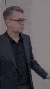 a man in a suit has a microphone around his ear