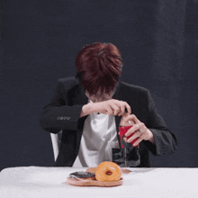 a man in a suit is holding a bottle that says black ice